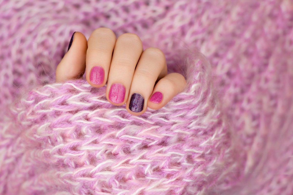 Pink nail design. Female hand with glitter manicure
